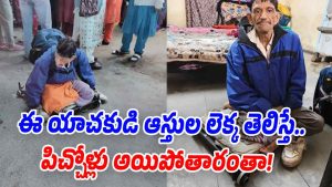 Mangilal, a disabled beggar from Indore, sitting on a metal board and begging on the roadside