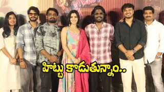 A group of filmmakers and cast members pose together on stage during a teaser launch event, smiling for the cameras.