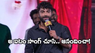 Actor Vishwak Sen speaking on stage with a mic at the Om Shanti Shanti Shantihi event, entertaining the audience with witty remarks.