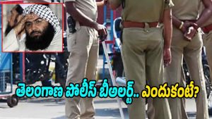 police personnel standing on a road in uniform with inset image of terrorist leader Masood Azhar indicating high security alert